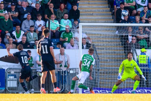 Despondent Hibs fans watch on as Aidan Nesbitt scores to make it 1-0 to Falkirk during the Premier Sports Cup match on Tuesday evening. Picture: SNS
