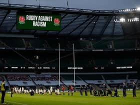 Some players stand and others take the knee in support of the Black Lives Matter movement ahead of the Six Nations rugby union match between England and Scotland at Twickenham Stadium in south west London on February 6, 2021. (Photo by Adrian DENNIS / AFP) (Photo by ADRIAN DENNIS/AFP via Getty Images)