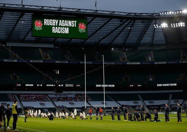 Some players stand and others take the knee in support of the Black Lives Matter movement ahead of the Six Nations rugby union match between England and Scotland at Twickenham Stadium in south west London on February 6, 2021. (Photo by Adrian DENNIS / AFP) (Photo by ADRIAN DENNIS/AFP via Getty Images)