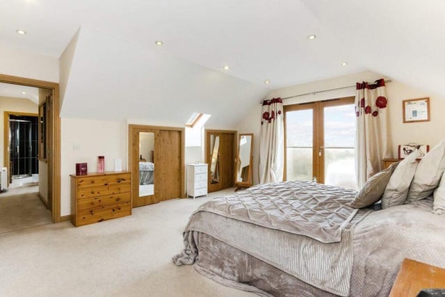 One of five generous bedrooms on the upper floor, the master suite is one of two which boasts an en-suite - if you can tear yourself away from the picture window.