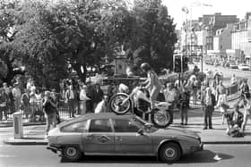 French circus Archoas can be seen here driving a motorbike over a car on Waverley Bridge as part of a publicity stunt for their Edinburgh Festival Fringe show. Year: 1989