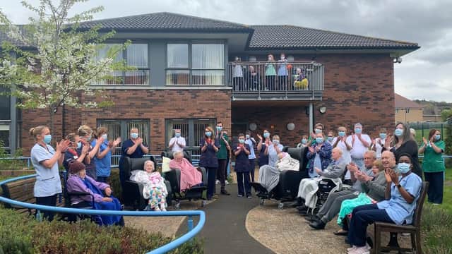 Drumbrae care home, seen with residents taking part in a Clap for Carers in April last year, could be closed and turned into a complex clinical care facility (Picture: Andrew O'Brien)