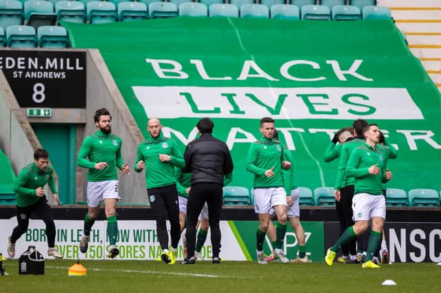 The Hibs players warm up in front of a Black Lives Matter banner at Easter Road
