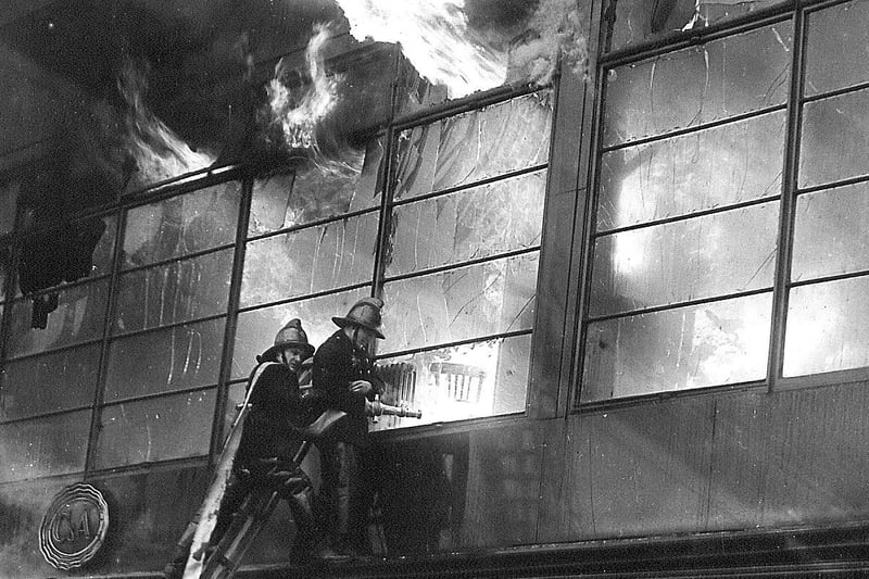 This dramatic photograph shows firemen on turntable ladders battling a blaze at C&A (then known as C&A Modes Ltd) on Princes Street, Edinburgh on November 9 1955.