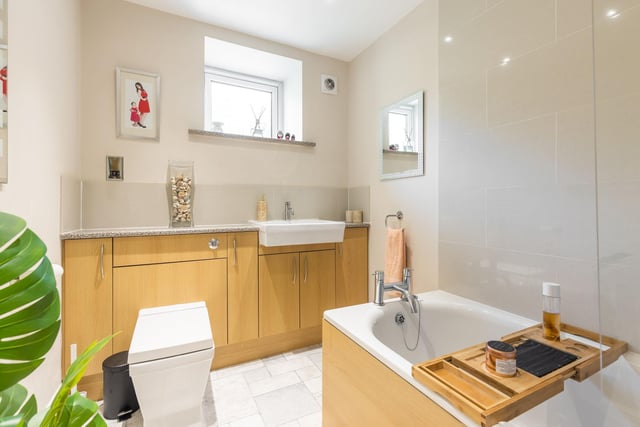 The stylish family bathroom comprises of a white three-piece suite with electric shower over bath.