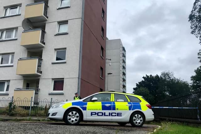 Police stand by the cordon outside the Holyrood Court flats on Thursday afternoon. Pic: Lisa Ferguson