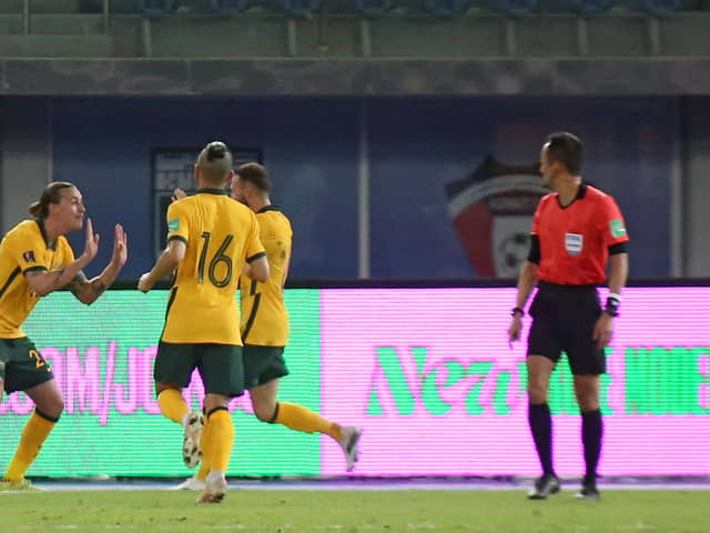 Jackson Irvine (l) celebrates after scoring the rebound from Martin Boyle's saved penalty as Australia defeated Kuwait in a World Cup qualifier at the Jaber Al-Ahmad Stadium in Kuwait City (Photo by YASSER AL-ZAYYAT/AFP via Getty Images)