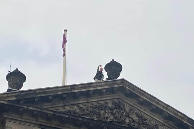 One young man on the Edinburgh City Chambers' roof on Tuesday evening (Photo: Lisa Ferguson).