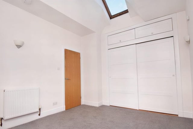 The property's main double bedroom has fitted wardrobes, newly laid carpet and Velux windows.