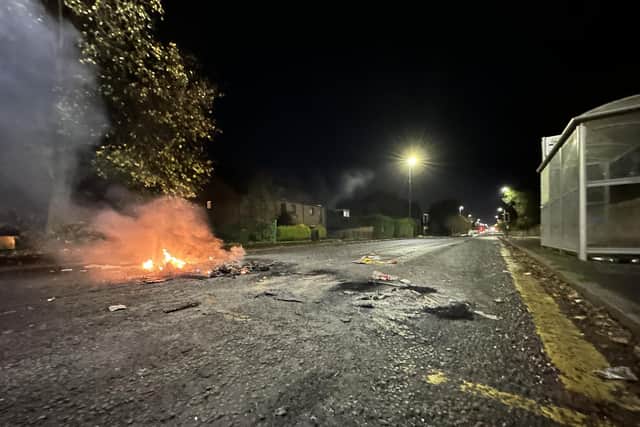 A fire was lit on a road blocking traffic