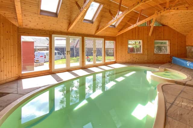 The swimming pool is located within its own purpose-built timber structure with a vaulted ceiling and stone tiled floor.