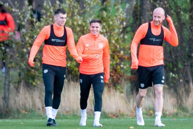 Ben Woodburn, Cammy Devlin and Liam Boyce training for Hearts yesterday. The striker is hoping to take part in small sided games today to test his calf for Fir Park