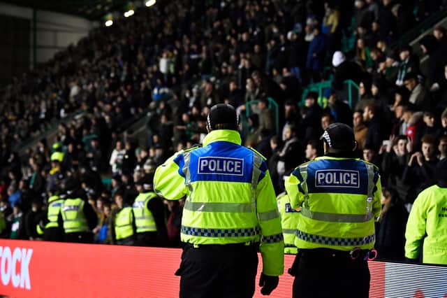 Police officers keep a close eye on Hibs fans during a game at Easter Road in 2019