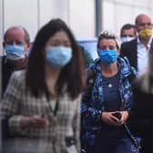 Crowd of people walking wearing masks. New postcode tracker is launched today as the country's council areas enter new five level system picture: JPI Media