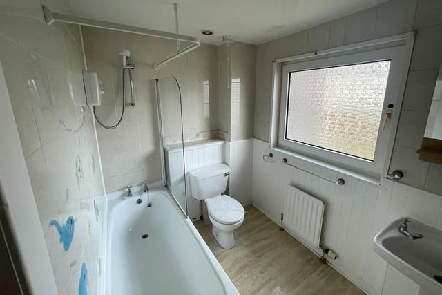 A generous-sized bathroom complete with a tub can be found upstairs