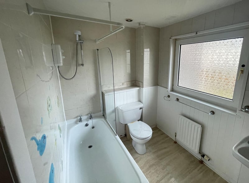 A generous-sized bathroom complete with a tub can be found upstairs