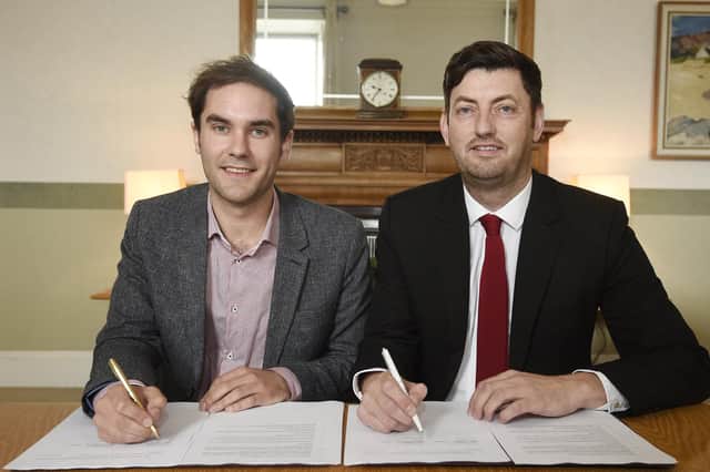 Group Leaders Councillor Adam McVey (SNP, left) and Councillor Cammy Day (Labour, right) sign the coalition agreement at the City Chambers (Picture: Greg Macvean)