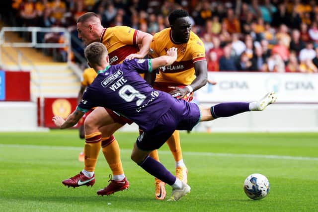 Bevis Mugabi of Motherwell gives Vente an enthusiastic welcome to Scottish football during the Steelmen's 2-1 victory over Hibs. Picture: Ewan Bootman / SNS Group