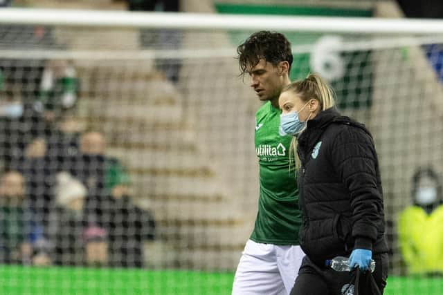 Joe Newell is helped off the park after sustaining an injury in the Edinburgh derby