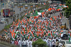 Members of India's Congress party carry a giant Indian national flag during a procession as part of the celebrations to mark country's 75th Independence Day in Chennai (Picture: Arun Sankar/AFP via Getty Images)