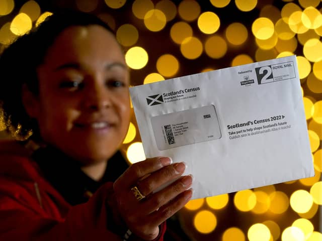 Postal worker Patrona Tunilla holds a sample Scotland's Census letter during its launch at the University of Glasgow (Picture: Andrew Milligan/PA)