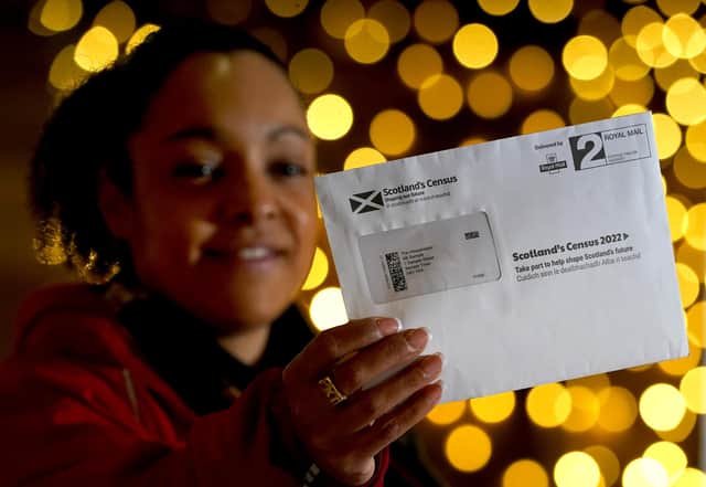 Postal worker Patrona Tunilla holds a sample Scotland's Census letter during its launch at the University of Glasgow (Picture: Andrew Milligan/PA)