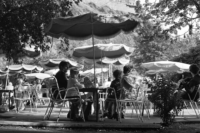 People enjoying the summer sunshine at The Piazza open-air cafe in Princes Street Gardens Edinburgh in August 1970.