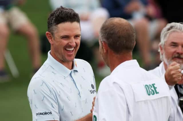 Justin Rose fist bumps his caddie, David Clark, after setting the pace in the 85th Masters at Augusta National Golf Club. Picture: Kevin C. Cox/Getty Images.