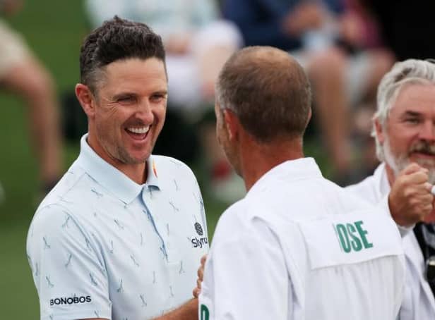 Justin Rose fist bumps his caddie, David Clark, after setting the pace in the 85th Masters at Augusta National Golf Club. Picture: Kevin C. Cox/Getty Images.