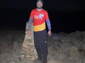 John summiting Scafell Pike during the night