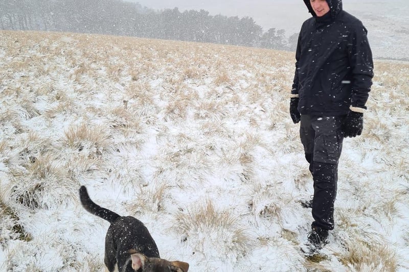 My teenager and his dog in the snow.