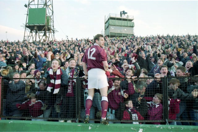 Hearts' Wayne Foster celebrates with Hearts fans after scoring the late winner in their 2-1 Scottish Cup victory over Hibs at Easter Road in February 1994.