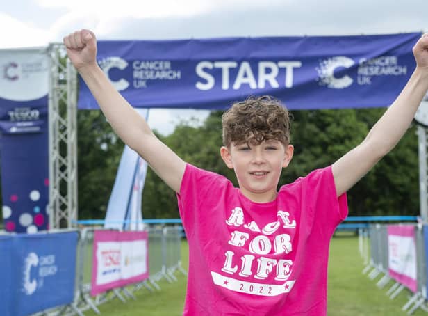 Leo Barker, an 11-year-old from Livingston who had a liver transplant during the pandemic after being diagnosed with cancer sounds the horn at the start of Pretty Muddy Kids at the the Meadow’s, Edinburgh. (Photo credit: Lesley Martin)
