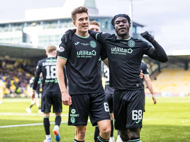 Élie Youan and Matthew Hoppe celebrate after combining for Hibs' second goal against Livingston
