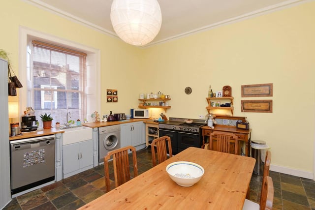 The dining kitchen overlooks the rear garden and offers a good range of fitted units that are topped with wooden work surfaces and arranged around a Belfast sink