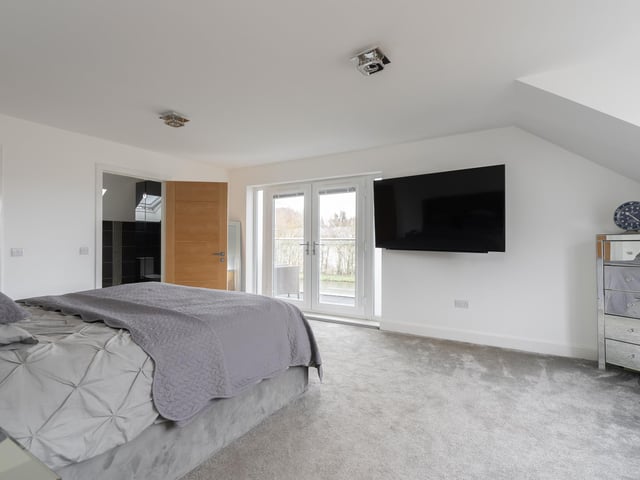 The large principal bedroom with walk in wardrobe, en-suite shower room and a west facing balcony with delightful canal views.