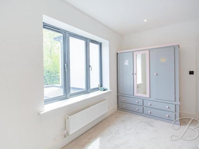Another bedroom which, like the others, is generously sized. This one offers views of the back of the Sheepwalk Lane property.