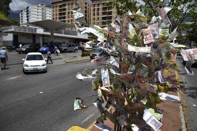 It may look like a 'magic money tree', but these banknotes on display in Caracas, Venezuela, are virtually worthless (Picture: Yuri Cortez/AFP via Getty Images)