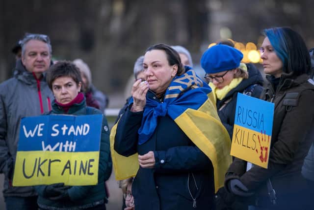 People gather for the Standing In Solidarity With Ukraine vigil on The Mound, Edinburgh, following the Russian invasion of Ukraine. Picture date: Tuesday March 1, 2022. PA Photo. See PA story POLITICS Ukraine. Photo credit should read: Jane Barlow/PA Wire