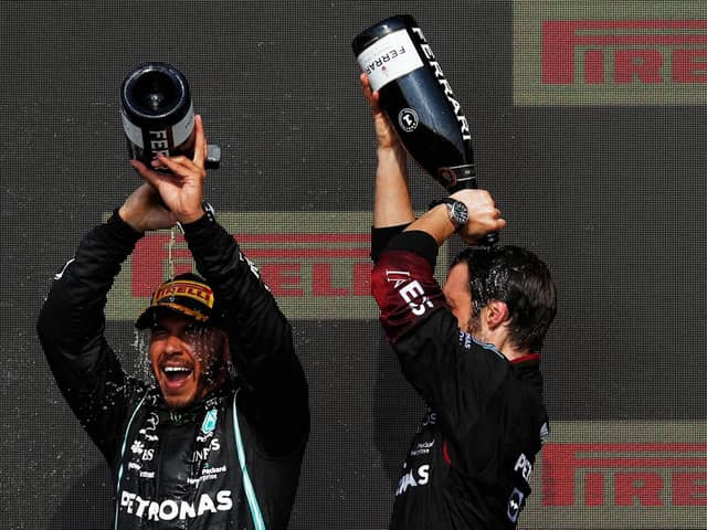 Lewis Hamilton, left, pours Champagne over his head on the podium after winning the Formula One Grand Prix at Silverstone (Picture: Adrian Dennis/AFP via Getty Images)