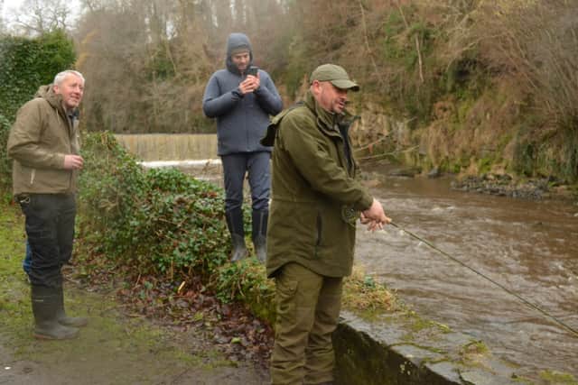 Adam Cross making the traditional first cast near Fair-a-Far weir. Scot Muir secretary of West Lothian Angling Association is on the left. Picture: Nigel Duncan