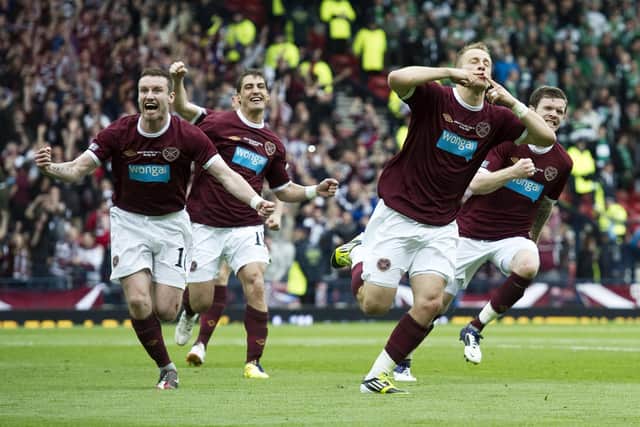 Hearts players celebrate after Danny Grainger, front-right, scores to make it 3-1 against Hibs in the 2012 Scottish Cup final. Picture: SNS
