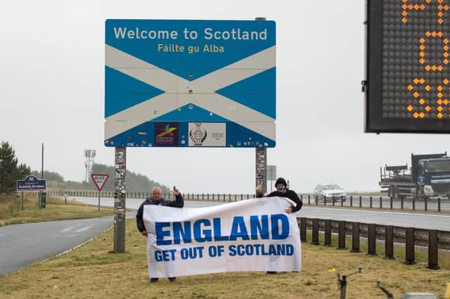 James Connelly and Sean Clerkin, of Action For Scotland, hold a banner at the Scottish/English border (Picture: Colin D Fisher/SWNS)