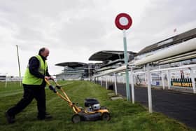 The world famous finish line for the Grand National being cut by Aintree Ground staff.