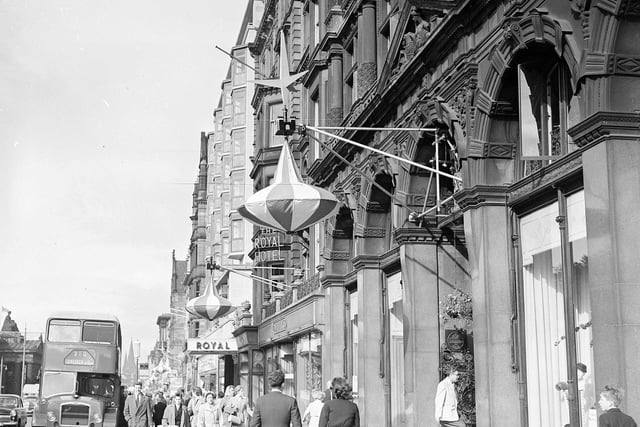 Here, you can see lantern style Edinburgh Festival decorations that have been hung up outside of Jenners on Princes Street. Year: 1957