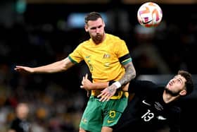 Martin Boyle challenges for an aerial ball against Liberato Cacace of New Zealand during Australia's 1-0 win in Brisbane. Picture: Getty