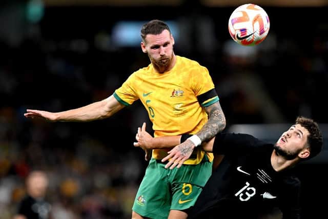 Martin Boyle challenges for an aerial ball against Liberato Cacace of New Zealand during Australia's 1-0 win in Brisbane. Picture: Getty