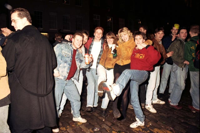 Revellers having a knees-up at the Tron kirk in Edinburgh on Hogmanay 1990.