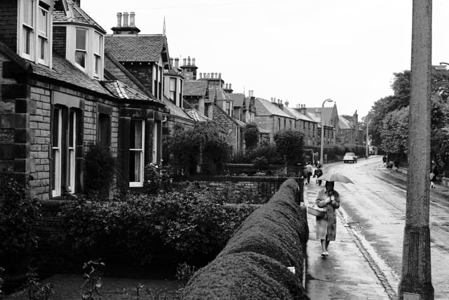 Front gardens with neatly trimmed hedges can be seen in this picture of Kirkgate, Liberton, in 1965.