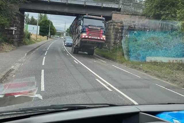 The skip lorry is stuck under the bridge, causing major delays.
Picture: Billy OFarrell